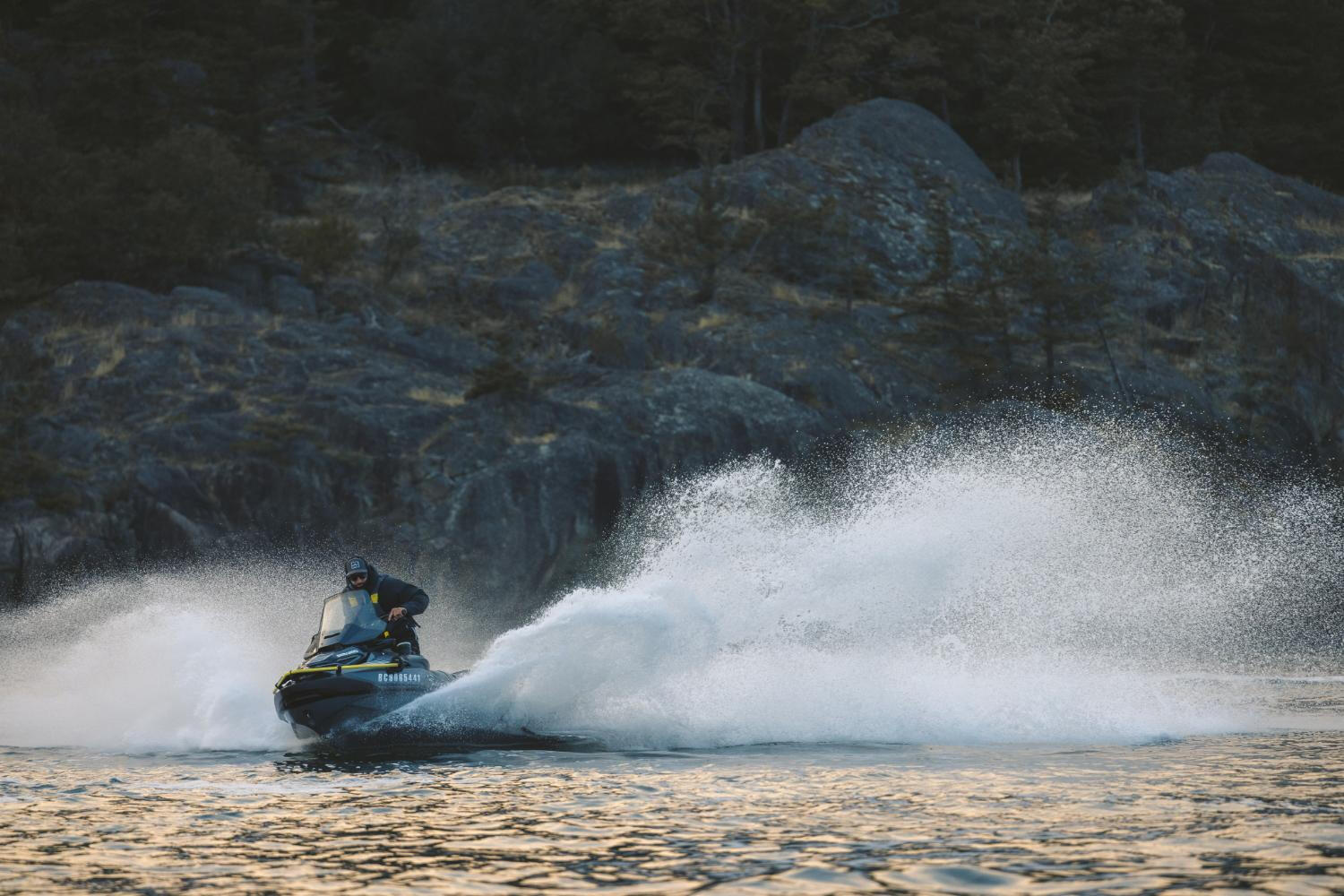 A rider navigates a jet ski on the water, showcasing excitement and adventure against a backdrop of waves.